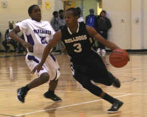 Lithonia's Kendall Evans (3) gets by Miller Grove's Collins Joseph (25). 