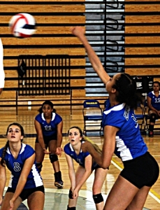 Chamblee's Kyla Manning (far right) sends a shot back against Tucker as teammates Natalie Roberts (8), Sydney Hicks (11) and Rachel Loftus (7) prepare for a possible return. (Photo by Mark Brock)