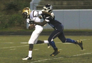 Cedar Grove's Alvin Williams (right) gets a big sack early in the third quarter against Tucker. (Photo by Mark Brock)