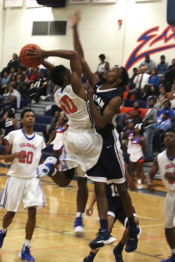 Columbia's Jalen Cobb (10) is defended by Redan's Darryl Moody (13). Cobb finished 19 points (5 three-pointers) in Columbia's 52-47 win. (Photo by Mark Brock)
