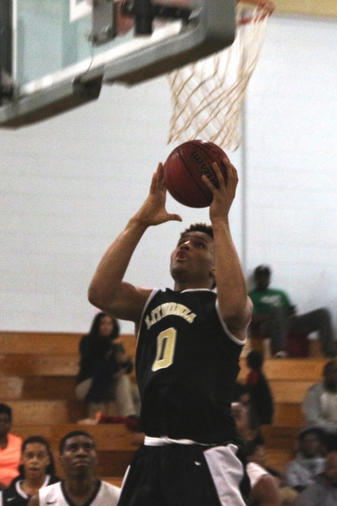 Lithonia's Jacara Cross goes in for two of his 21 points against Redan. (Photo by Mark Brock)