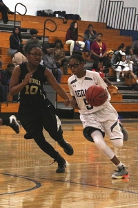 Redan's Kerrigan Johnson (5) drives against Lithonia's Kayln Greer (10) during first half action of Redan's win. (Photo by Mark Brock)