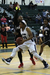 Arabia Mountain's Samantha Pringle (30) drives against Stone Mountain's Jamila Dickerson. Pringle won tournament MVP honors in leading Arabia Mountain to its second consecutive title. (Photo by Mark Brock)