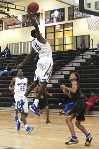 Meridian's Tyron Brewer flies to the basket against Osceola. (Photo by Mark Brock)