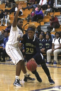 Southwest DeKalb's Daisa Alexander (20) drives against Miller Grove's Alexia Strong (33). Alexander led the Lady Panthers with a game-high 20 points in the win. (Photo by Mark Brock)