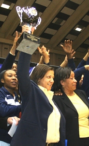 Southwest DeKalb's Kathy Walton holds up her fourth state championship trophy.
