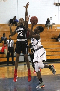 Redan's BriAllen McIver (right) puts up a shot against Stone Mountain's Kacian Lawrence (22) during Redan's Region 6-4A win over their DeKalb County rival. (Photo by Mark Brock)