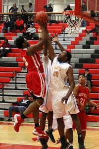 Druid Hills' Jordan Foote (10) gets off a shot against a pair of Mays defenders in the Red Devils tough Region 6-5A loss. (Photo by Mark Brock)