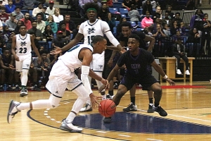 Miller Grove's Aaron Augustin (1) defends against McIntosh's Will Washington during the Wolverines 72-52 Class 5A semifinal win. (Photo by Mark Brock)