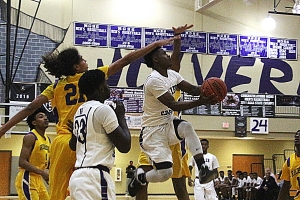 Miller Grove's Alterique Gilbert splits defenders on his way to the goal in the Wolverine's come-from-behind 64-57 win over Richmond Academy. (Photo by Mark Brock)