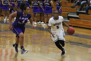 Stephenson's Miracle Gray (5) drives past Miller Grove's Imani Richardson in Stephenson's Region 6-5A victory.  (Photo by Mark Brock)