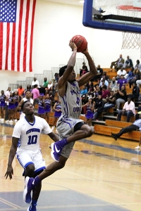 Miller Grove's Raylon Richardson (4) goes in for a dunk on a breakaway as Stephenson's Deion'Tray Fagin (10) tries to catch up.  (Photo by Mark Brock)