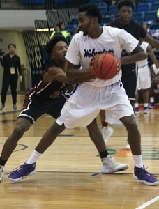 Miller Grove's Raylon Richardson protects the basketball while looking for an opening during the Wolverines' 66-41 Elite 8 win over South Paulding. (Photo by Mark Brock)