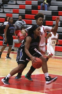 Stephenson's Nailah Manning (11) drives the lane against Banneker in Stephenson's playoff clinching win. (Photo by Mark Brock)