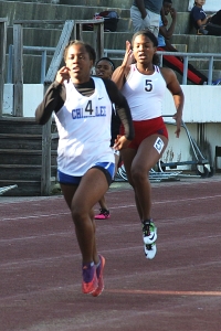 Chamblee's Venida Fagan aided the Chamblee title defense cause with a win in the 400 meter dash. Dunwoody's Madison Beecher (red shorts) trails in the race to the finish line. (Photo by Mark Brock)