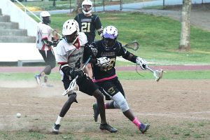 Druid Hills' Willie Jordan (left) and Lakeside's James Jackson (right) battle each other for a ground ball. (Photo by Mark Brock)