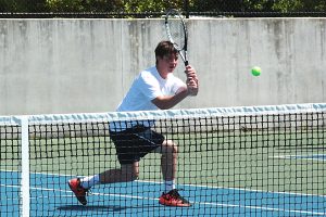 Dunwoody's JT Melton hits a backhand return in the No. 1 doubles match victory with Daniel Bynum.  (Photo by Mark Brock)