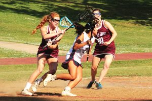 Senior Kyra Perry (white jersey) finished her home career with six goals and two assist in Dunwoody's 12-7 win over Union Grove.  (Photo by Mark Brock)