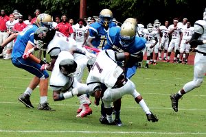 Chamblee running back Joshua Tate (4) bulls his way into the end zone against Druid Hills. (Photo by Mark Brock)
