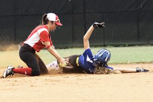 Chamblee's Rachel Lovejoy gets under the tag of Druid Hills' shortstop Eliza Dean (left) during first inning action at Chamblee. (Photo by Mark Brock)