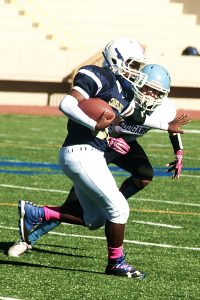 Chapel Hill running back Akin Fears (with ball) eludes an Henderson defender on a 33-yard run. (Photo by Mark Brock)