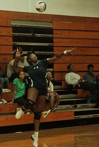 Redan's Johnquanek Spencer serves up an ace against Savannah during the Raiders 3-1 Class 3A first round playoff victory. (Photo by Mark Brock)