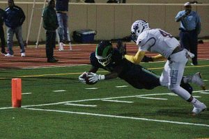 Arabia Mountain's Carl White (with ball) dives to the corner of the end zone for a first half touchdown in the Ram's historic first playoff game victory. (Photo by Mark Brock)