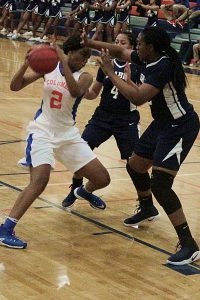 Arabia Mountain's Iyanna McMillian (4) and Iyanla Kitchens (right) double-team Columbia's Deidra Harris (2). (Photo by Mark Brock)