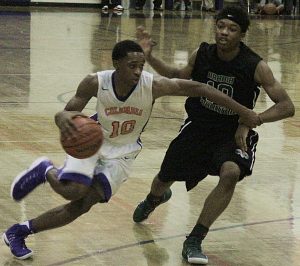 Columbia's Jalen Cobb drives against Arabia Mountain's Kamaal McCain. Cobb hit 4 free throws in the final 7 seconds to propel Columbia to the Region 5-5A victory at home. (Photo by Mark Brock)