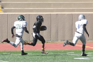 DCSD (Lithonia) running back Narvin Booker (black jersey) has a 40 yard gain to set up a touchdown. APS Montrez Williams and Chase Stokes ran him out of bounds at the 2. (Photo by Mark Brock)