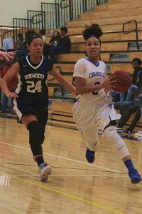 Chamblee's Tori Syphoe (2) gets past Dunwoody's Tia Fuller (24) during Chamblee's 51-44 win. Syphoe hit for 25 points in the game.  (Photo by Mark Brock)
