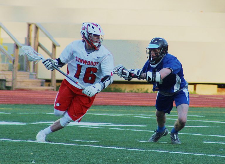 Dunwoody’s Sean Fox (16) works against Chamblee defender Bart Turney during the Wildcats’ 17-5 win in the first meeting of the two teams. (Photo by Mark Brock)