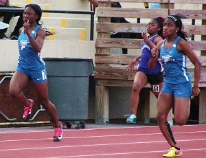 Stephenson's Marisa Mayfield (far right) moves in front in the 100 meter dash as teammate Amanda King (far left) and Miller Grove's Travyonna Manuel work hard to keep up. (Photo by Mark Brock)