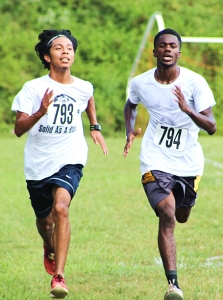 Cedar Grove's Luis Vazquez (left) edged out teammate Mikaiel Jack for first in the first boys' varsity race at Arabia Mountain on Tuesday. (Photo by Mark Brock)