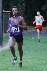 Lakeside junior Mikias Mekonen (left) pulls away from Druid Hills' senior Carter Rathur on the way to the country's fastest time. (Photo by Mark Brock)