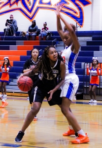 Lithonia's Zaryanna Mitchell (12) looks for room to score against Columbia defender A. Maddox. Columbia won the Region 5-5A contest 69-22. (Photo by Mark Brock)