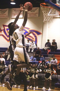 Lithonia's Bryson Rockcliffe (10) makes a layup during the Region 5-5A boys' tournament. Rockcliffe helps lead his Bulldog teammates into a second round clash with Rome on Thursday at 6:00 pm. (Photo by Mark Brock)