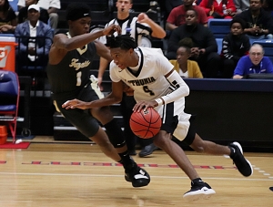 Lithonia's Eric Gaines (4) drives against Fayette County's King Calhoun (1) during second half action of Lithonia's overtime loss in the Class 5A boys' state semifinal game. (Photo by Mark Brock)