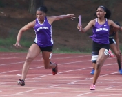 Miller Grove's Tacari Demery (left) took the baton from teammate Chance Barnes and cliched first in the 4x100 meter relay at the DCSD County Championships in March.. The pair hope to lead the Lady Wolverines to a state track championship this weekend. (Photo by Mark Brock)