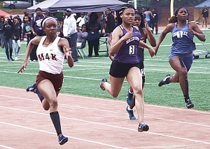 Martin luther King's Kayla Hunt (left) swept a pair of close races with Miller Grove's Angelica Frederick (center) to win gold in the 100- and 200-meter dashes. (Photo by Mark Brock)