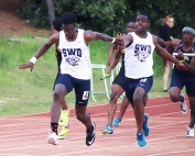 Southwest DeKalb's Jalon Kimbrough (left) takes the baton from teammate Tommy Wright on the way to the gold in the 4x100-meter relay. (Photo by Mark Brock)
