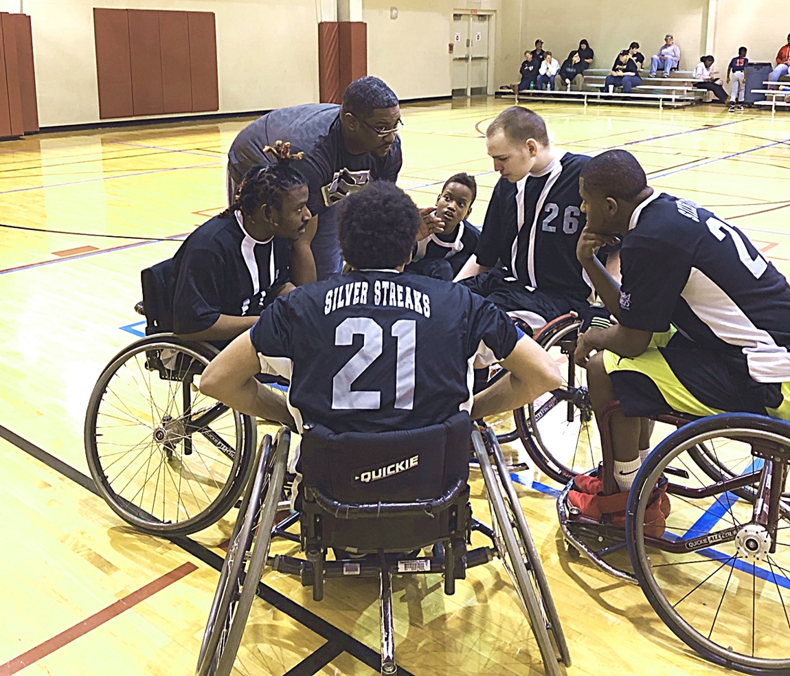 Strategy talk during a timeout against the Houston Jr. Sharks.