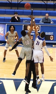 Tucker's Nate Ogbu gets the Tigers' Class 6A state semifinal game underway with this tip-off against Heritage. (Photo by Lester Wright)