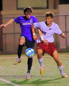 Lakeside's Carter Hunnicutt (13) battles Lambert's Hayden Fontana (19) for the ball. (Photo by Mark Brock)