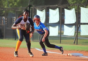 Southwest DeKalb first baseman Aniyah Lee (left) hit a huge fifth inning grand slam homer in the Lady Panthers' 8-6 win over Chamblee's Emily Katz (right) and her teammates at Chamblee on Thursday. (Photo by Mark Brock)