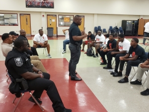 DeKalb County Police officers meet with McNair High football team members as part of the partnership with the NFL and HELP.