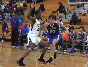 Miller Grove's Michael Lewis (30) tries to cut off Chamblee's Will Mepham (23) as he goes baseline during Miller Grove's win on Tuesday. (Photo by Mark Brock)