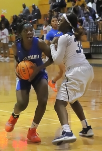 Columbia's Elese Warren (with ball) works inside against Southwest DeKalb's Aniyah Lee (34). Warren had an 11-point, 10 rebound double-double in the game won by Lee and her Lady Panther teammates 44-42. (Photo by Mark Brock)