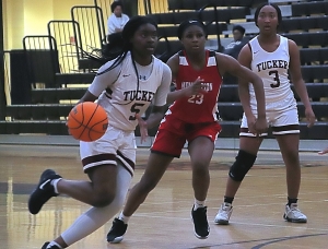 Tucker's Kennedy Collins (5) drives against Mt. Zion's K. Hayes (23). (Photo by Mark Brock)
