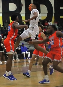 Lithonia's Franklin Champion (with ball) flies to the basket against Columbia's Devin Longstreet (24) and Nigel Emile (25) during the No. 1 ranked Bulldogs big win. (Photo by Mark Brock)